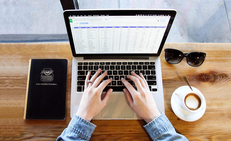 An employee sifting through spreadsheet data.