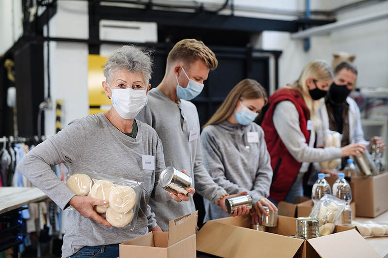 Foodbank volunteers boxing cans during the pandemic.